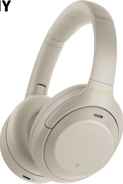 Cream over-ear headphones photographed against a plain pale background