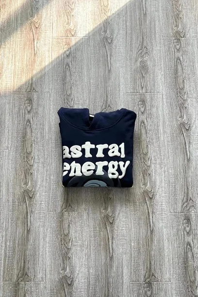 Folded navy hoodie with white lettering on weathered wood