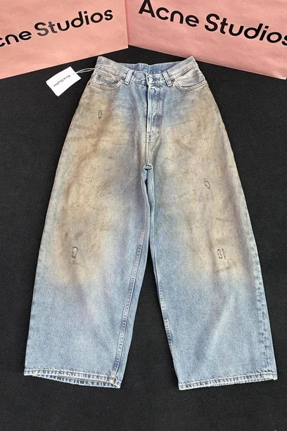 Pale wide-leg jeans laid flat, photographed under a header card from the shop