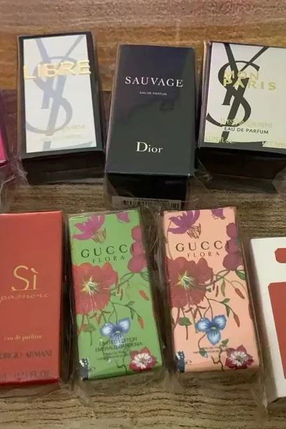 Several boxed fragrances arranged together on a wooden surface